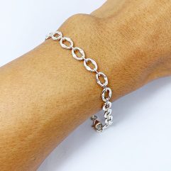 A detailed close-up of a handcrafted 925 sterling silver square box braided chain bracelet, featuring a prominent circular pendant clasp, worn on a wrist.