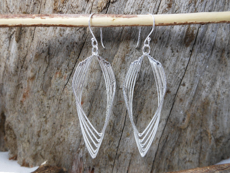 A pair of handcrafted 925 sterling silver multi-layered leaf-shaped drop earrings featuring an intricate interlocking wire design, captured with a high-polished finish.