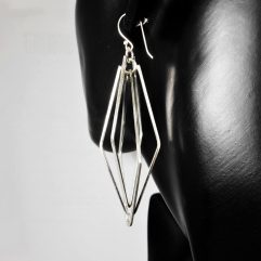 A pair of handcrafted 925 sterling silver spinning rhombus geometric drop earrings displayed on a black mannequin, highlighting their multi-layered design.