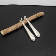 A pair of handcrafted 925 sterling silver puffy long teardrop stud dangle earrings featuring a smooth, high-polished finish.