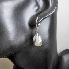 A pair of handcrafted 925 sterling silver puffy teardrop earrings featuring a smooth, high-polished finish and a secure leverback closure.