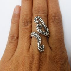 A handcrafted 925 sterling silver wrap ring featuring a detailed octopus tentacles design with textured suction cups, shown on a hand.