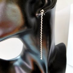 A pair of handcrafted 925 sterling silver long bar dangle earrings featuring a textured, shiny finish and a minimalist stud post design.