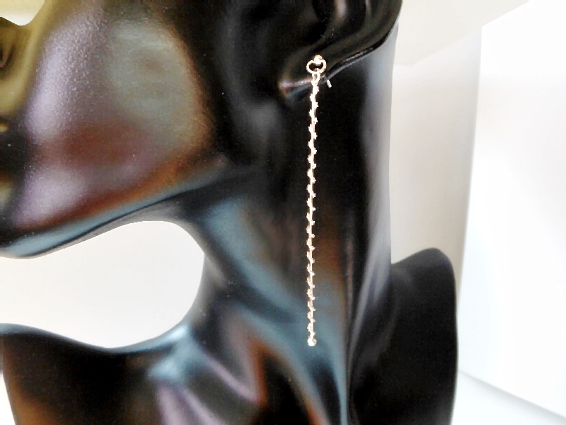 A pair of handcrafted 925 sterling silver long bar dangle earrings featuring a textured, shiny finish and a minimalist stud post design.
