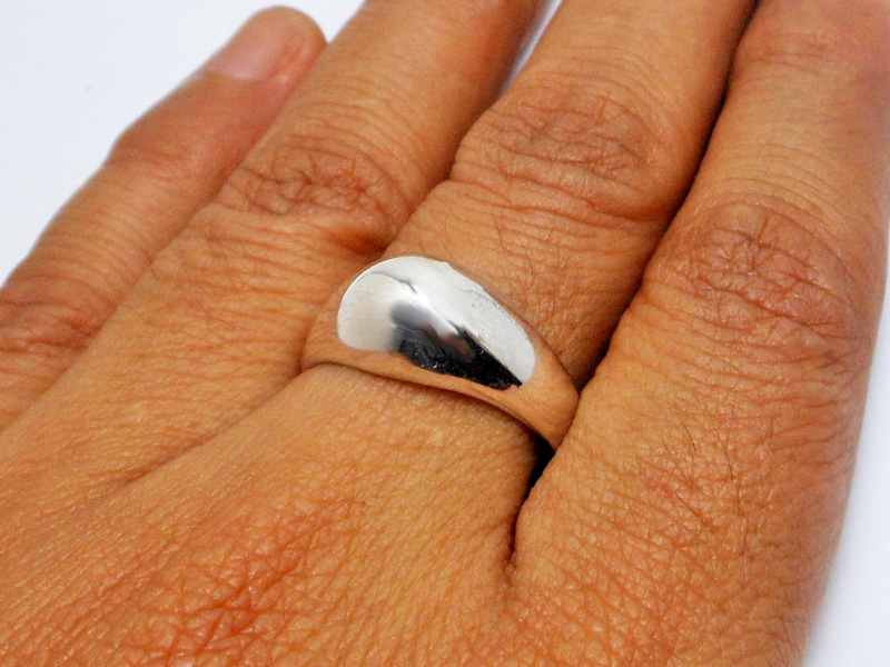 A sleek, handcrafted 925 sterling silver tapered dome ring with a high-polished finish, shown on a hand.