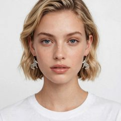 Front-facing view of a model wearing the sterling silver cutout zebra dangle earrings.