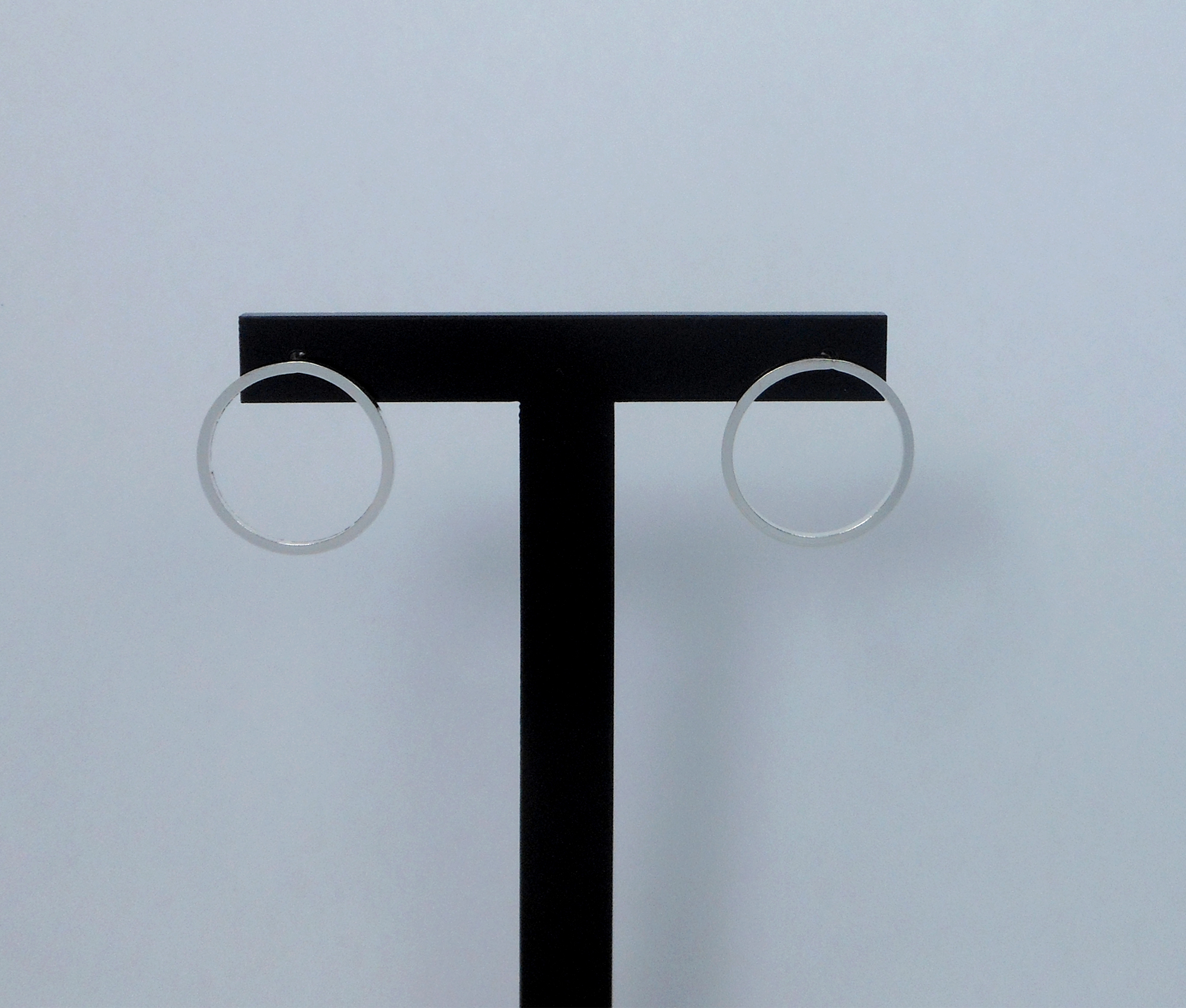 Pair of handmade 925 sterling silver convertible earrings shown as simple circle studs