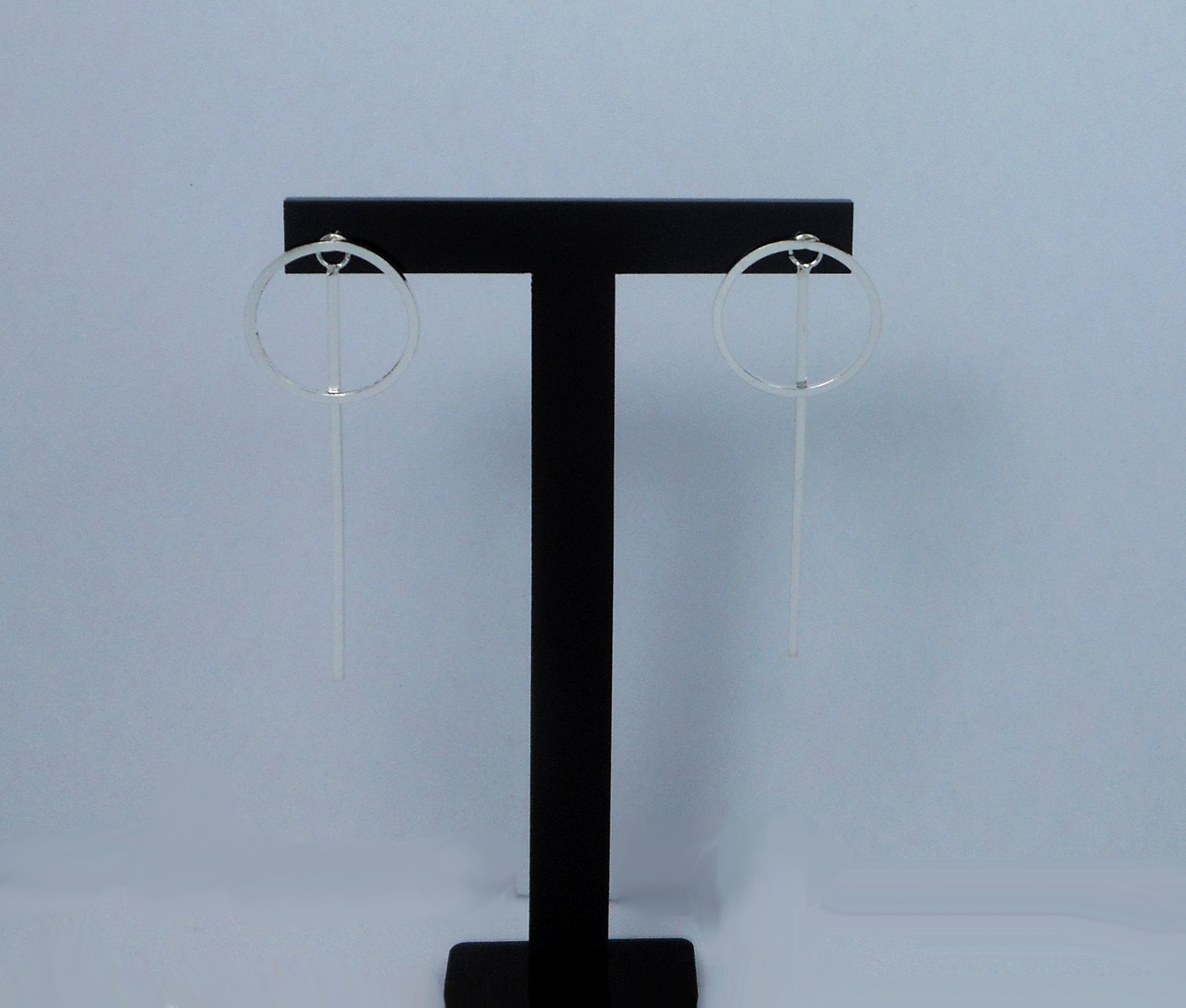 Pair of handmade 925 sterling silver convertible earrings shown as circle-and bar dangle earrings.