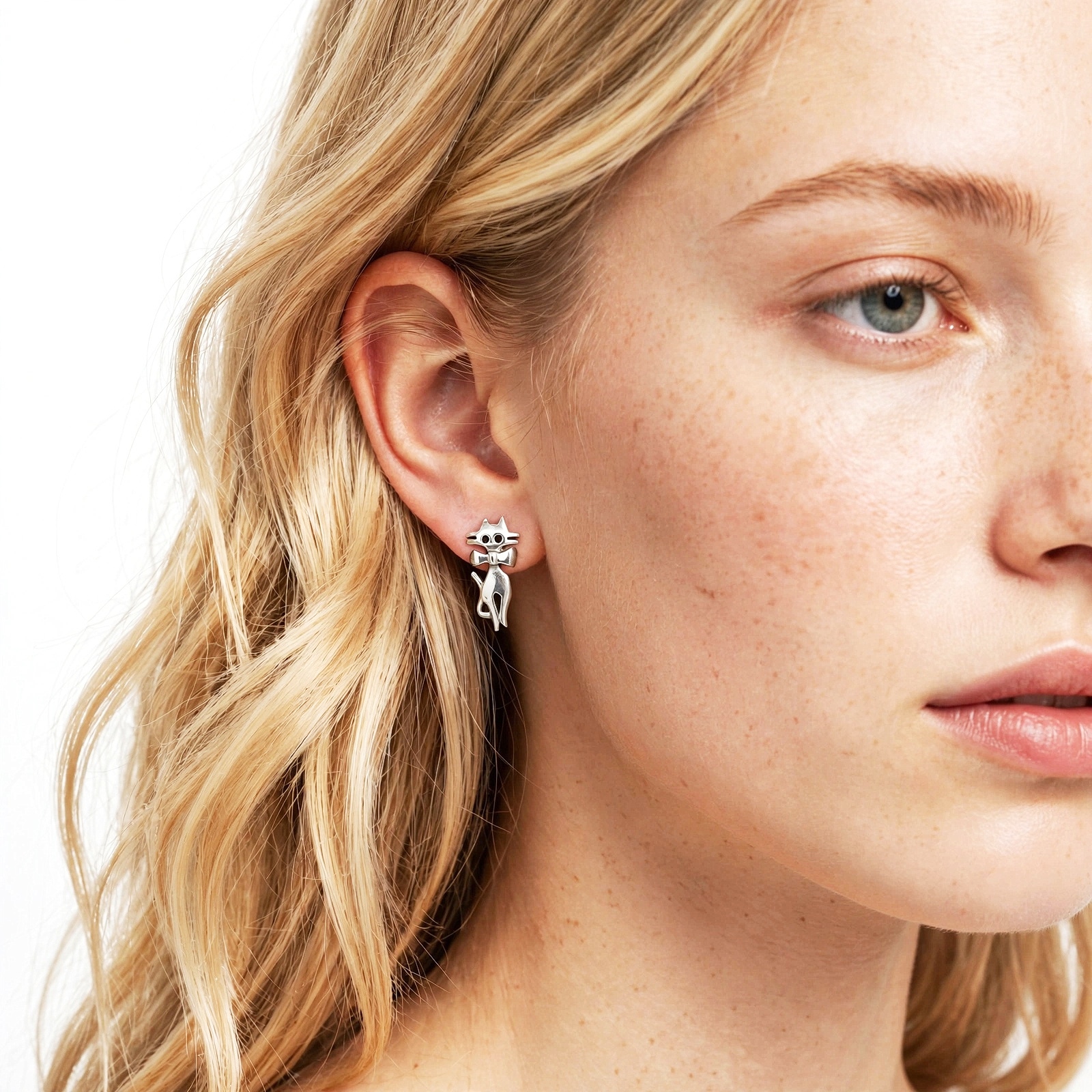 model wearing minimalist 925 sterling silver cat stud earrings on ear.