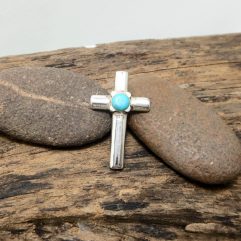 925 Sterling Silver Turquoise Cross Pendant on natural rustic background