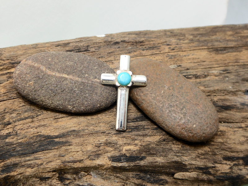 925 Sterling Silver Turquoise Cross Pendant on natural rustic background
