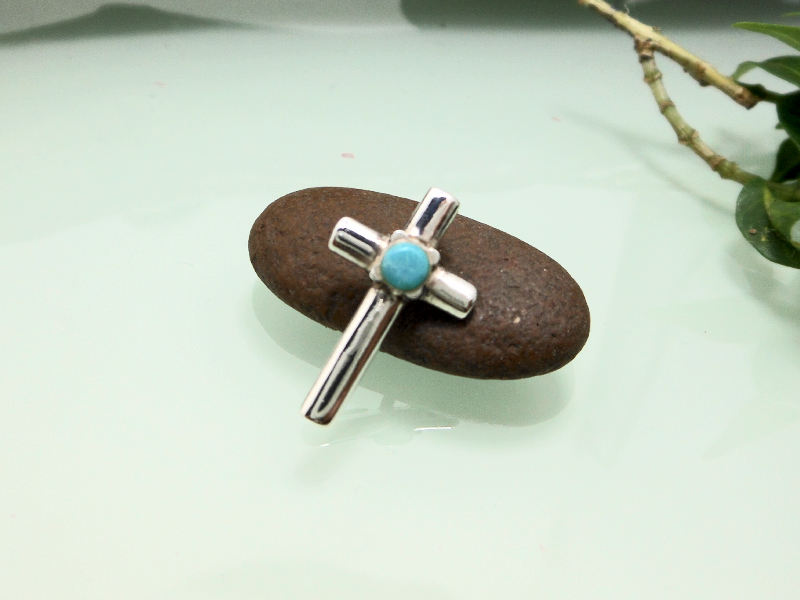 925 Sterling Silver Turquoise Cross Pendant on dark stone display