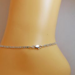 Close-up of a 925 sterling silver Valentino chain anklet worn on an ankle