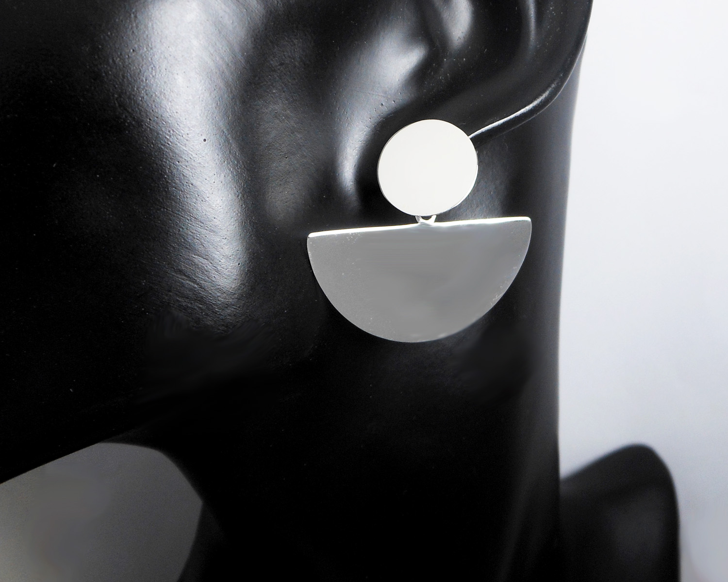 Pair of handmade 925 sterling silver fan-shaped half-circle dangle stud earrings featuring a high-polished mirror finish on a black mannequin.