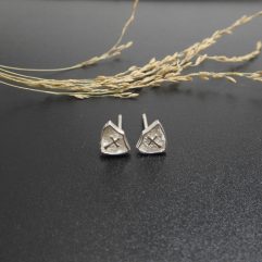 Pair of handmade 925 sterling silver stud earrings in a triangle shape with a textured cross design.