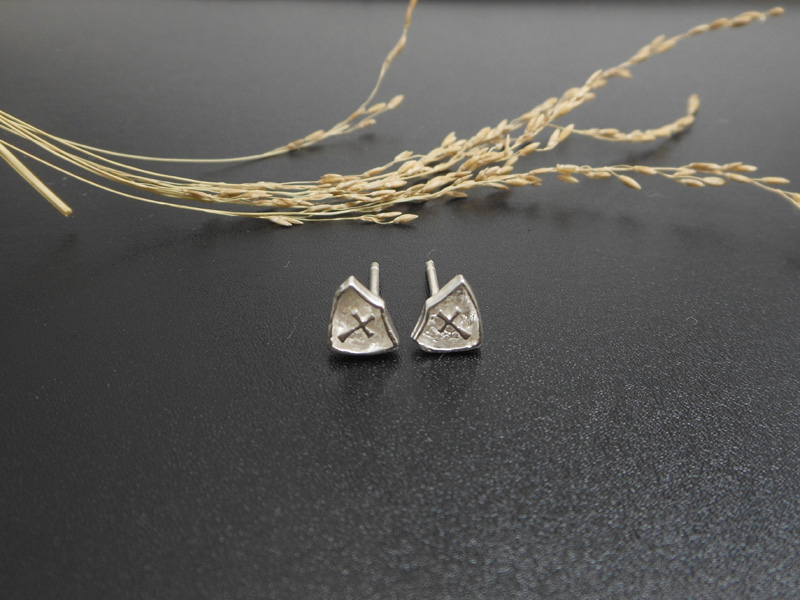 Pair of handmade 925 sterling silver stud earrings in a triangle shape with a textured cross design.