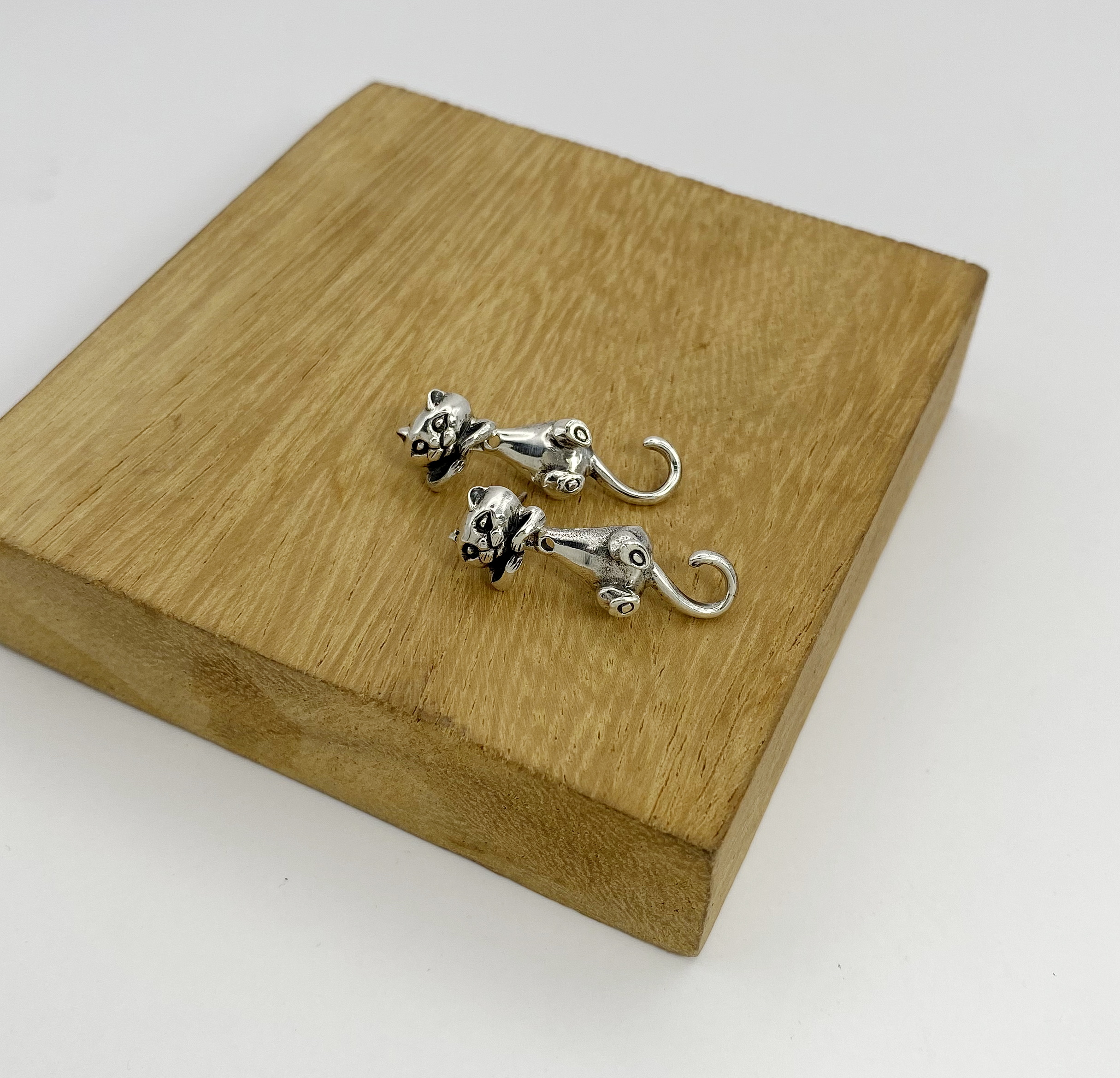 925 sterling silver cat earring jackets on wooden display