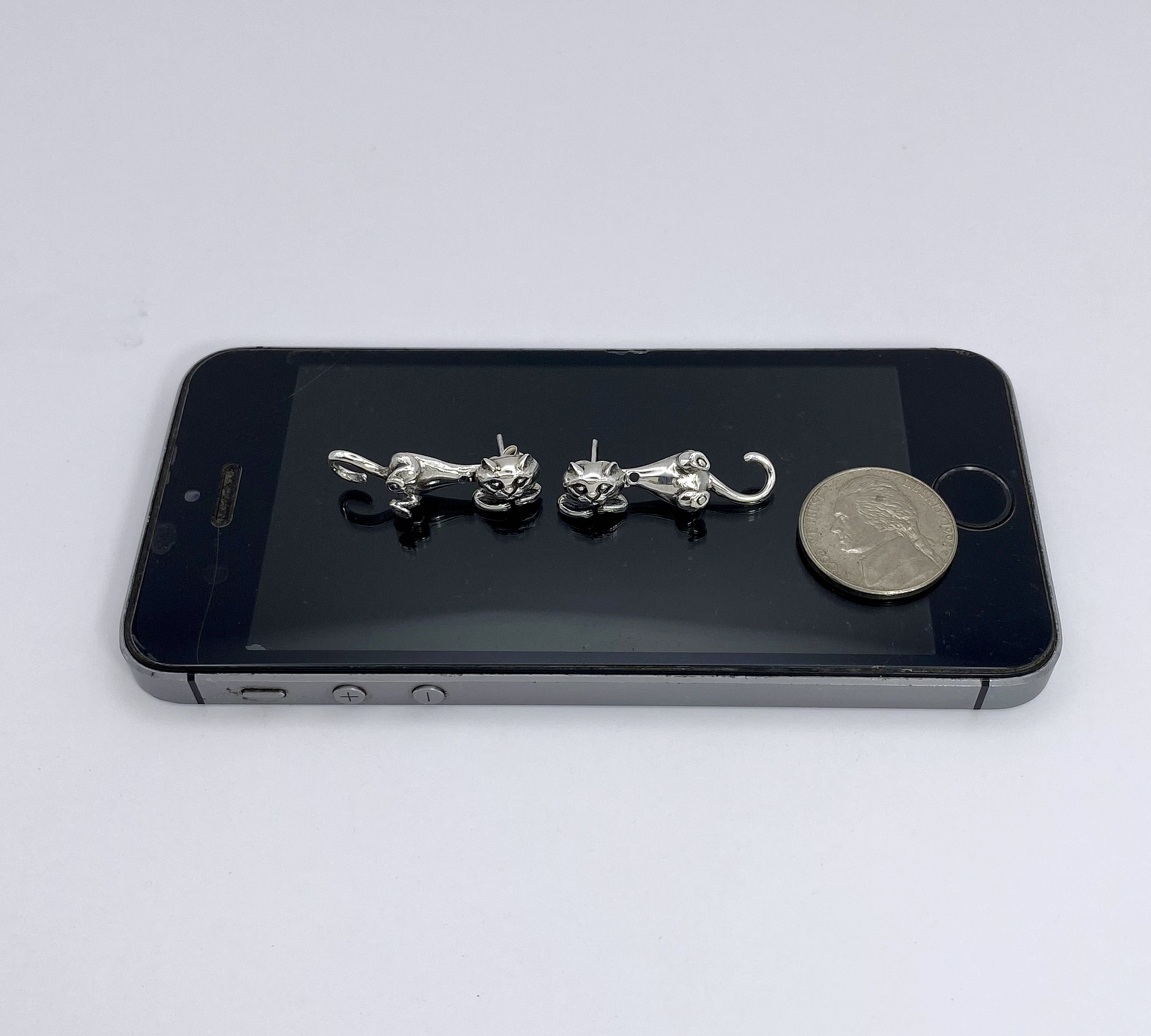 To help you visualize the size, we have included a photo of the cat earring jackets placed next to a common coin.