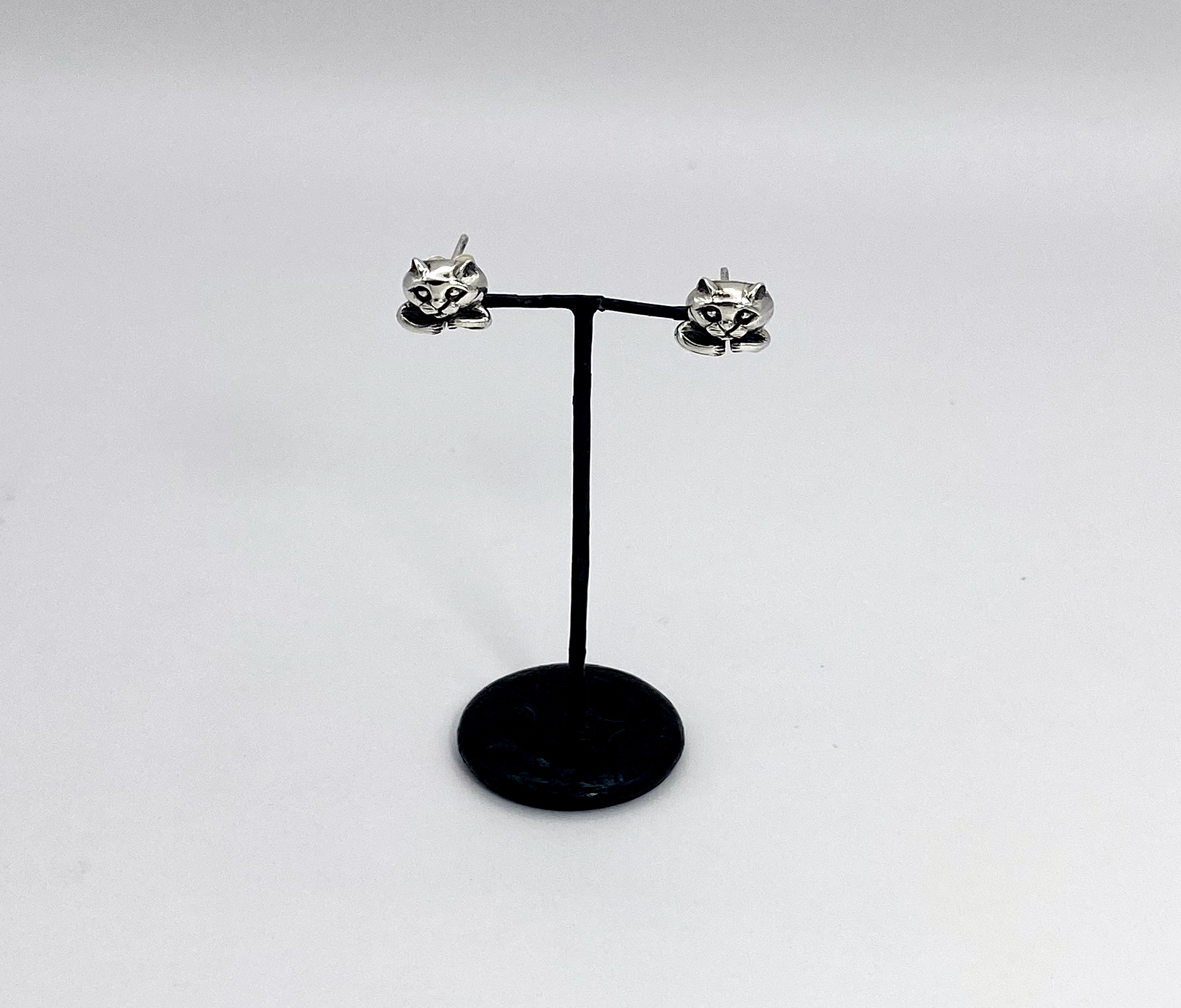 Cat earring jackets on earring stand, front view