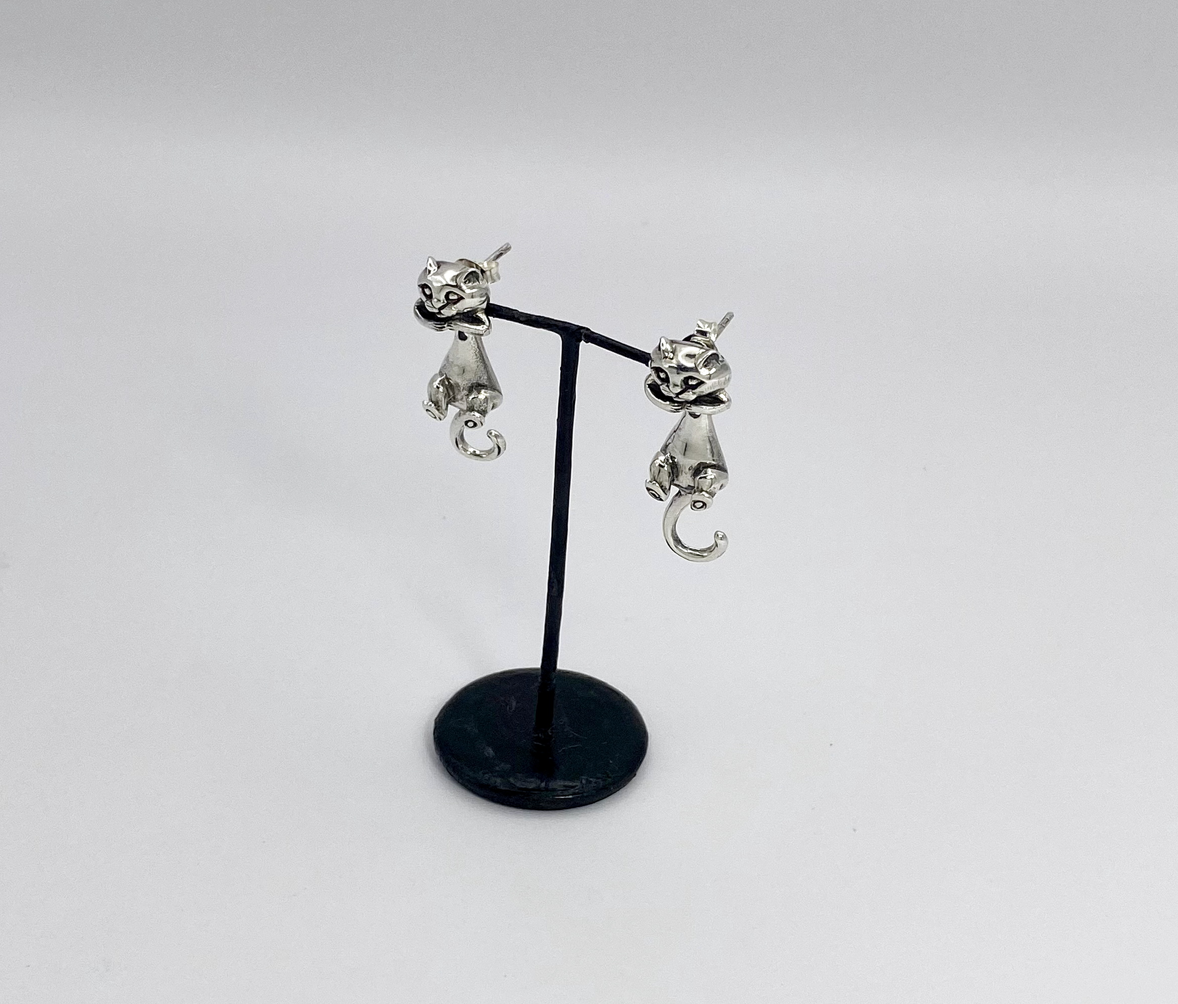 Pair of cat earring jackets, front view on stand