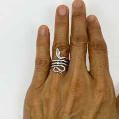 Handcrafted 925 sterling silver ring featuring an elegant coiled snake design, shown worn on a finger.