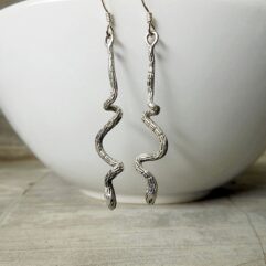 Pair of slithering snake earrings in 925 sterling silver with high-quality scale engraving and dark finish.