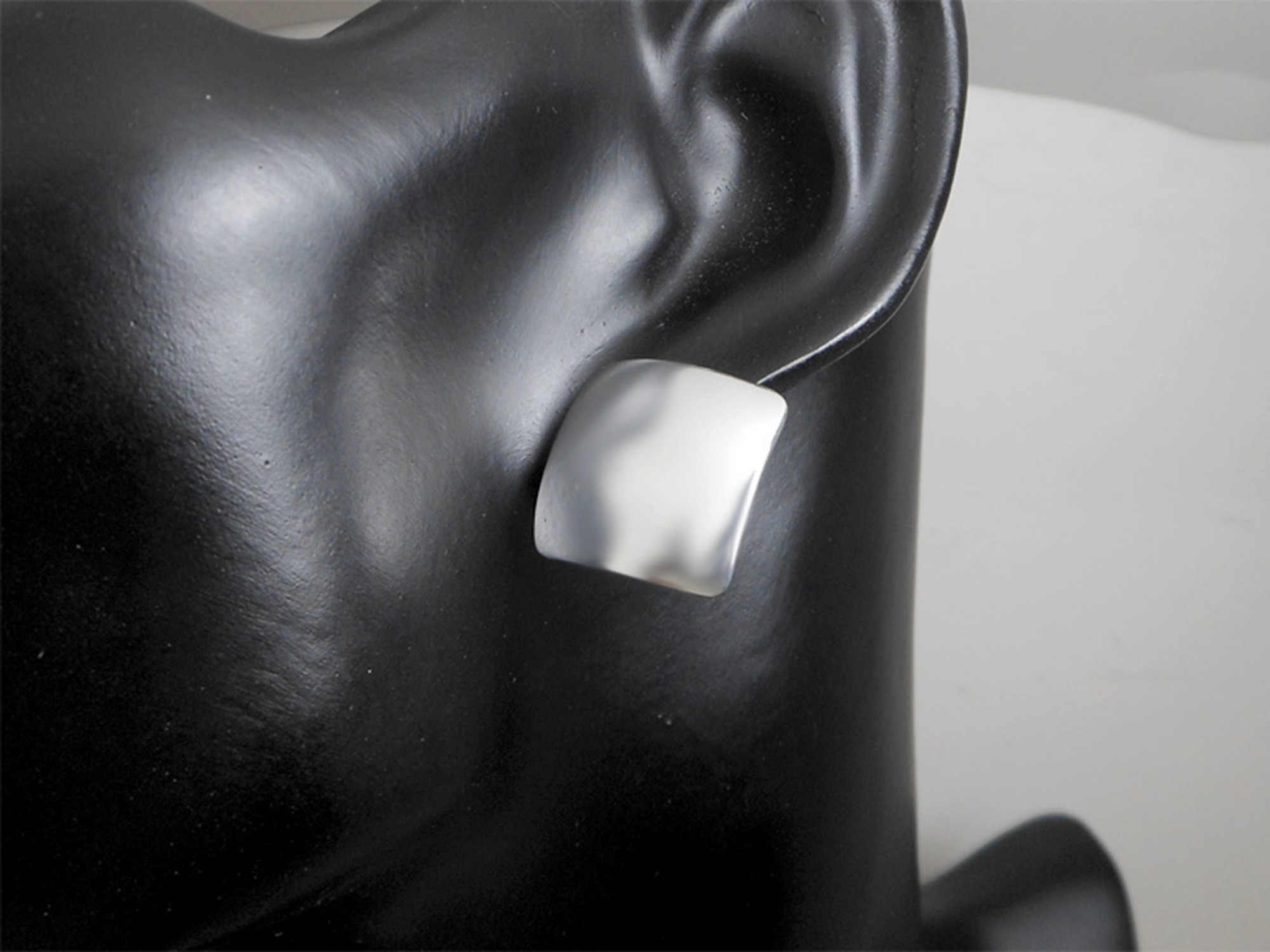 Pair of handmade 925 sterling silver dome square stud earrings with a smooth, high-polished finish.