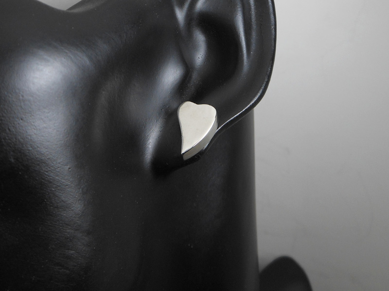 Pair of handmade 925 sterling silver puffed heart stud earrings with a smooth, high-polished finish.