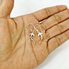 Sterling silver hammerhead shark earrings front view on hand