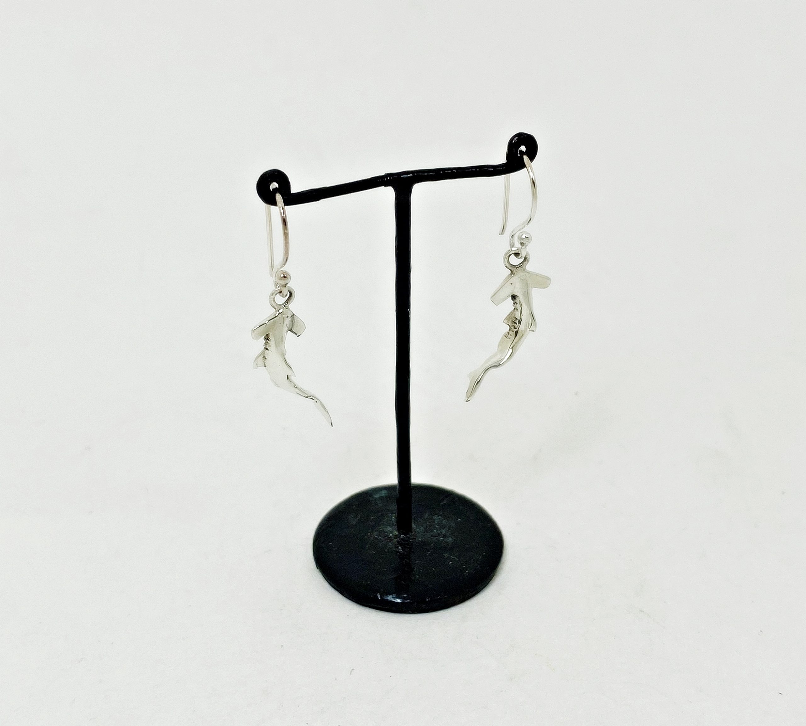 Hammerhead shark silver drop earrings left side view on display stand