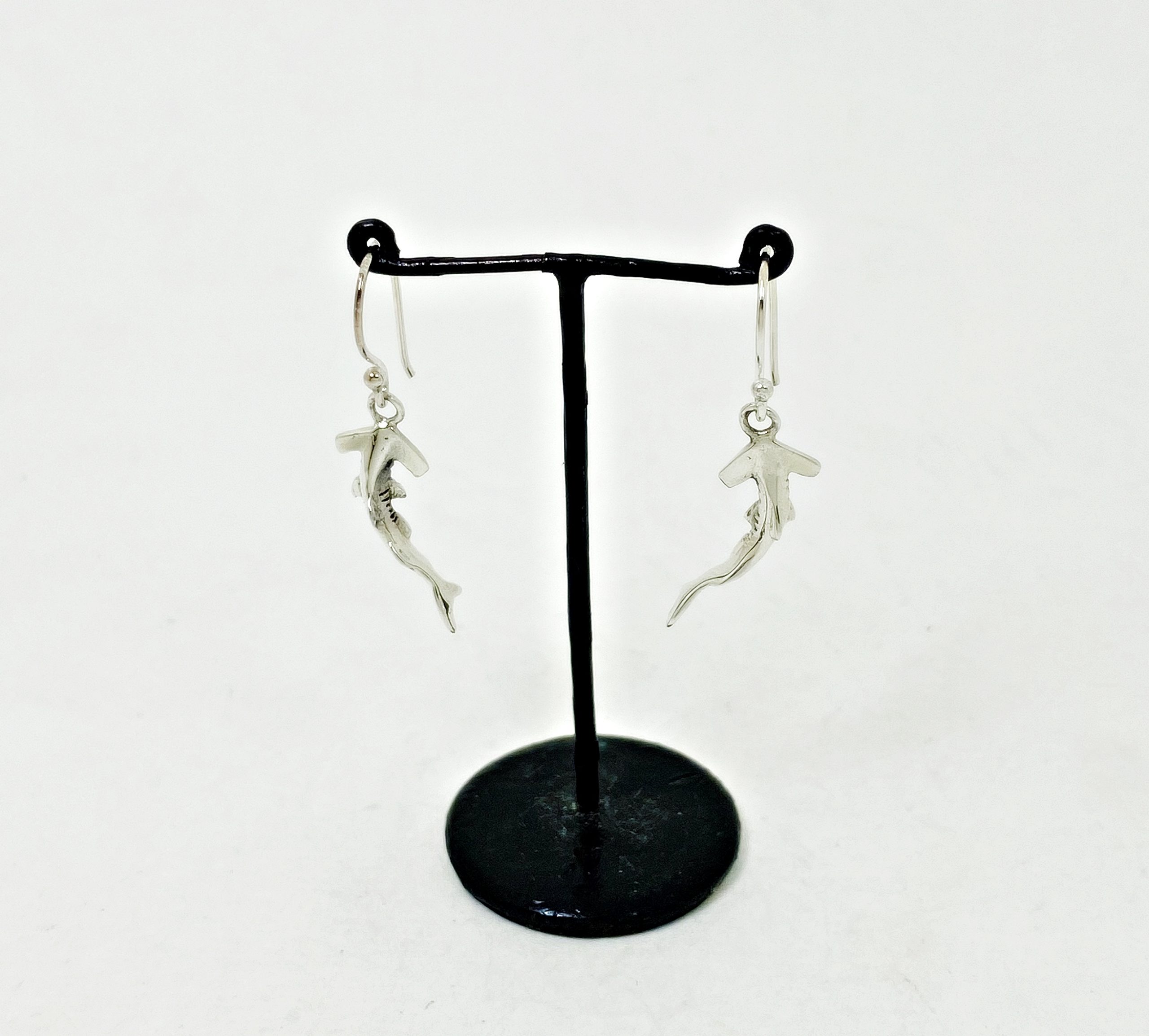 925 sterling silver hammerhead shark earrings on a black display stand