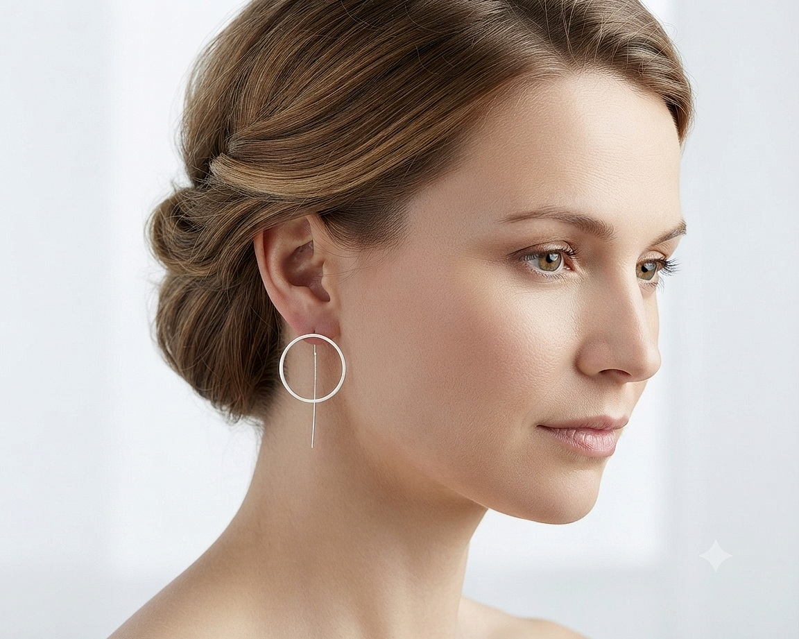 A model wearing handmade sterling silver circle threader earrings.
