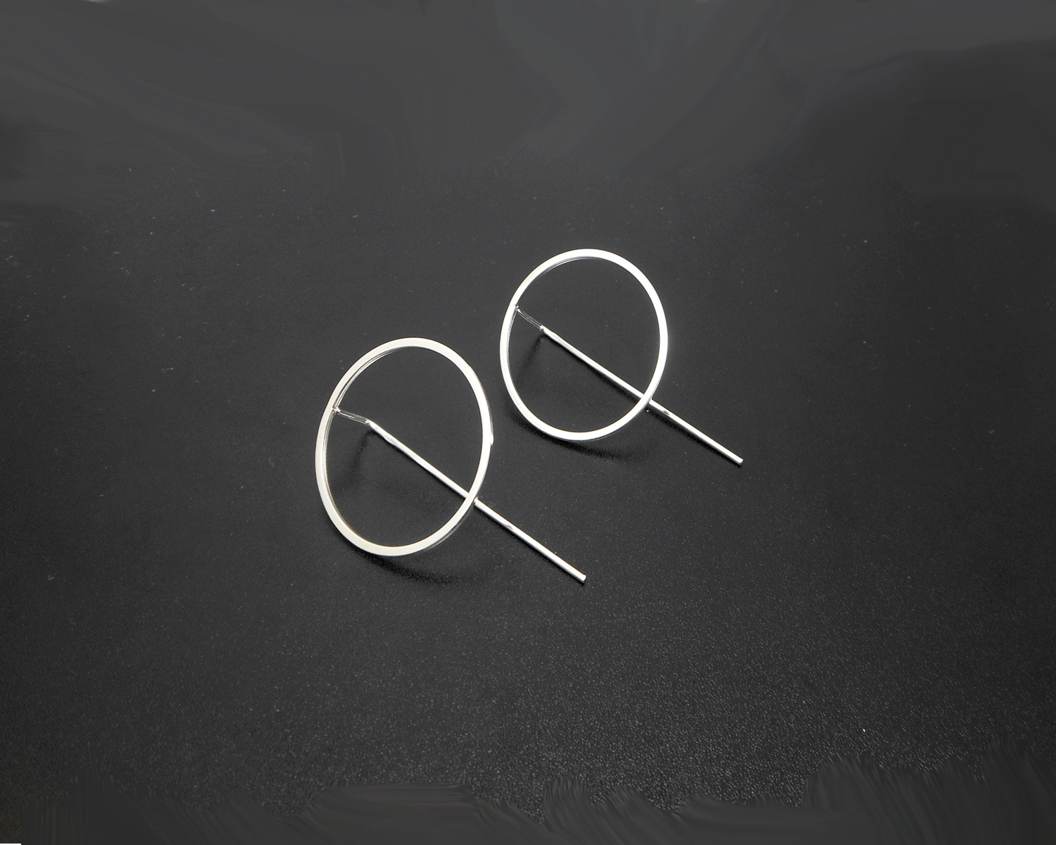 Pair of minimalist circle threader earrings.