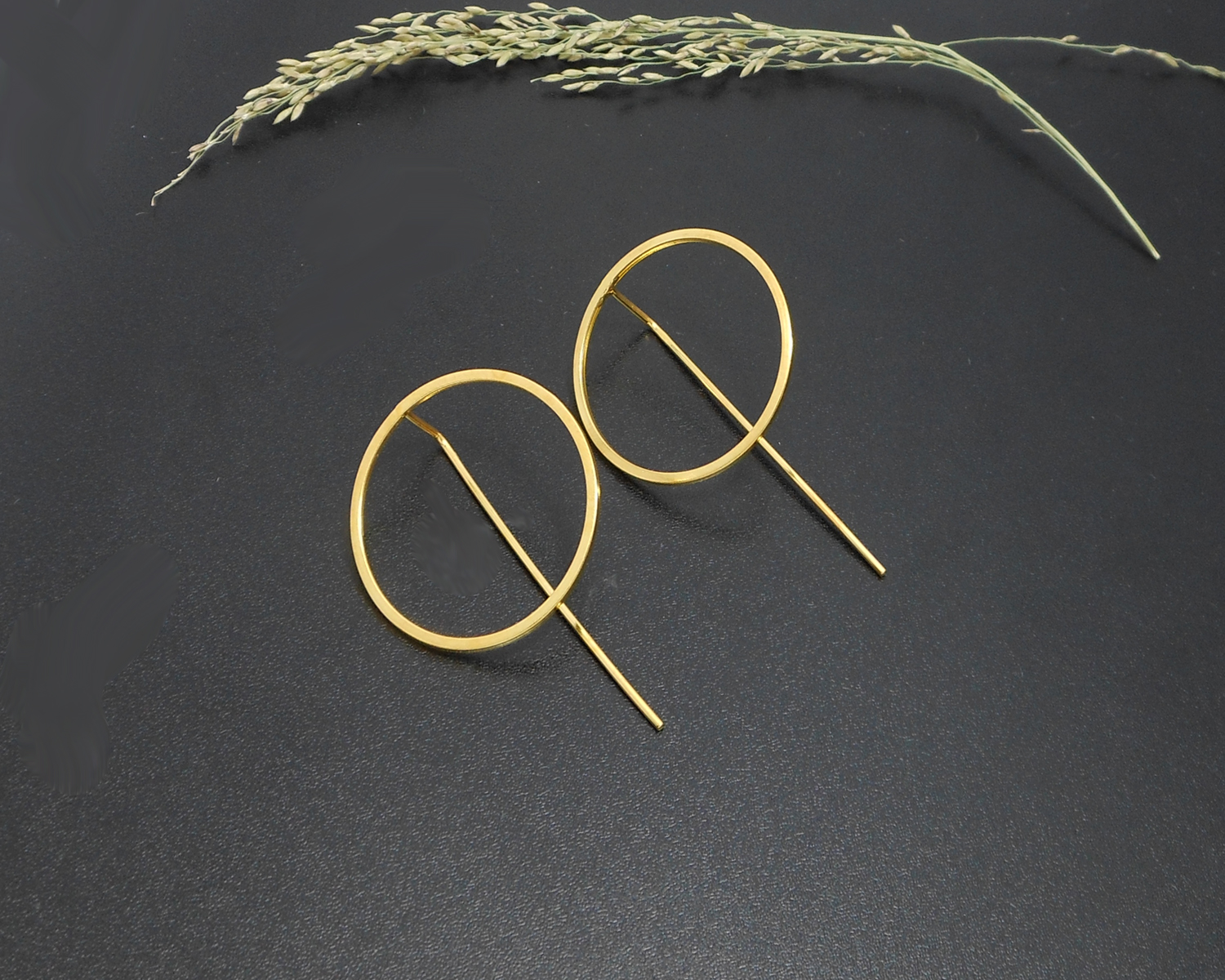 Gold circle threader earrings with natural accents.