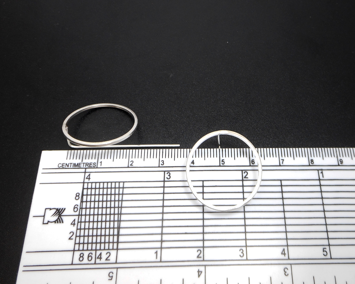 Circle threader earrings shown with a measuring tool for size reference.