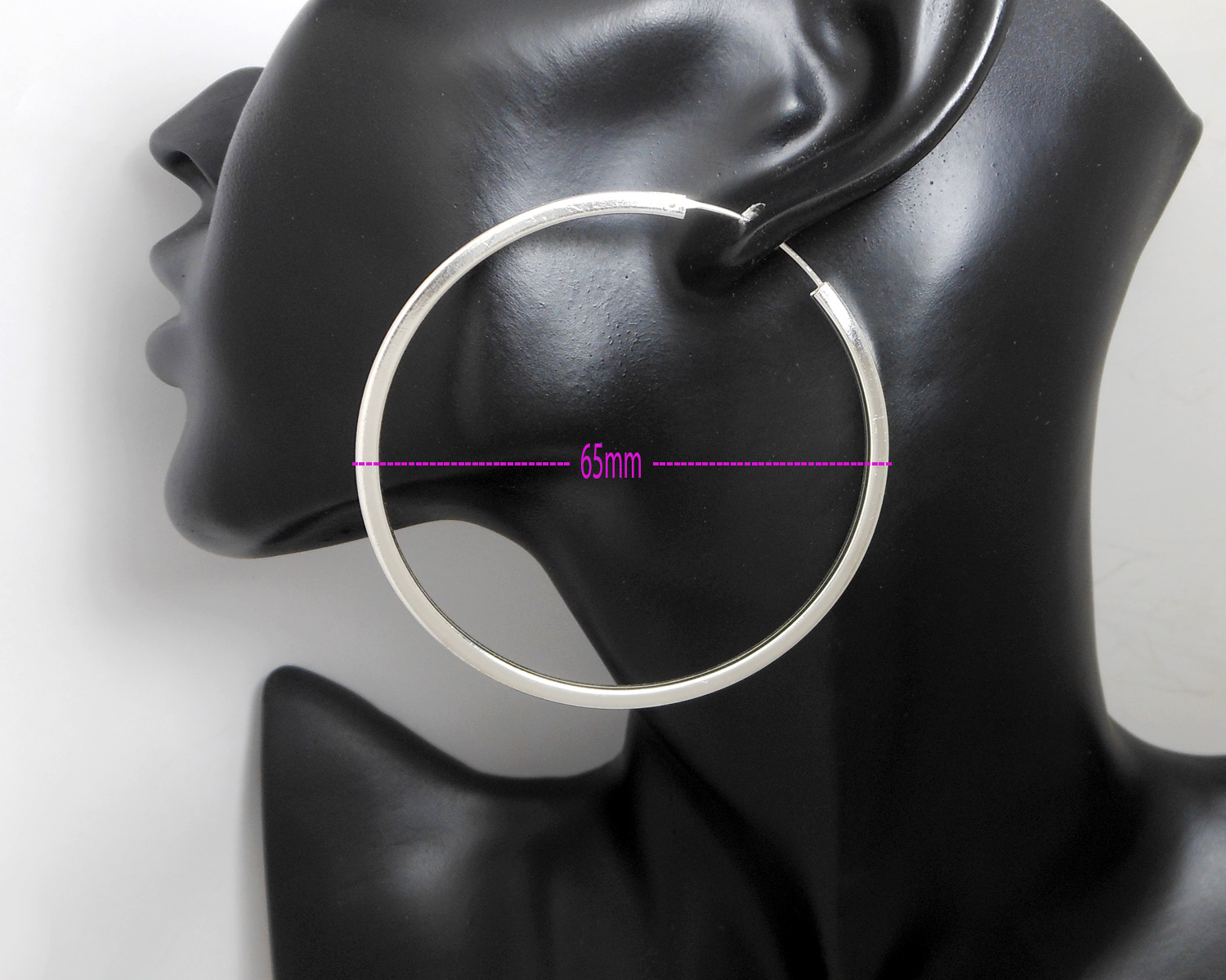 A pair of large, 65mm handmade 925 sterling silver hoop earrings featuring a unique square tube profile, displayed on a mannequin