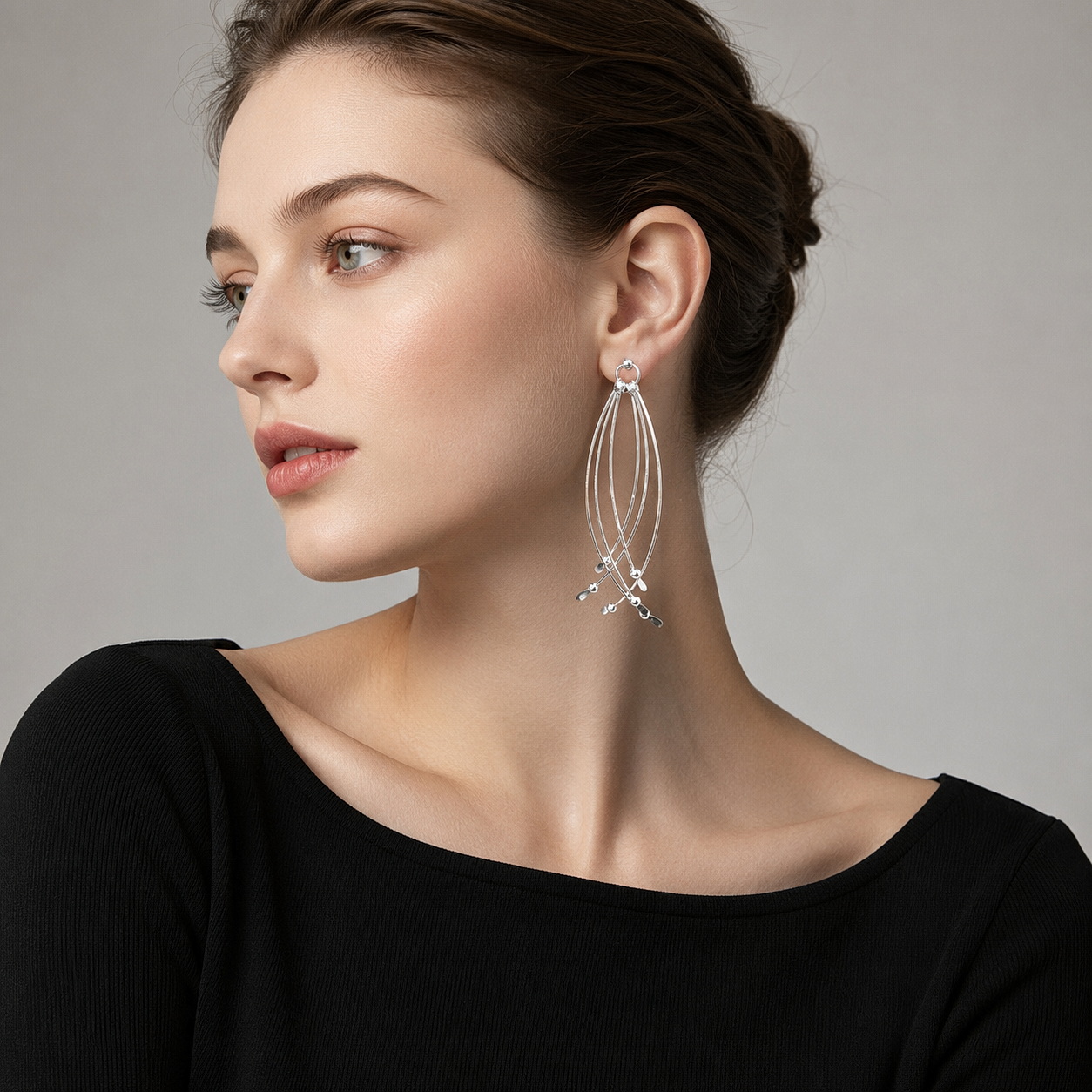 European model wearing handmade 925 sterling silver multi-bar long dangle earrings (E474-M) with a black top on a light gray studio background.