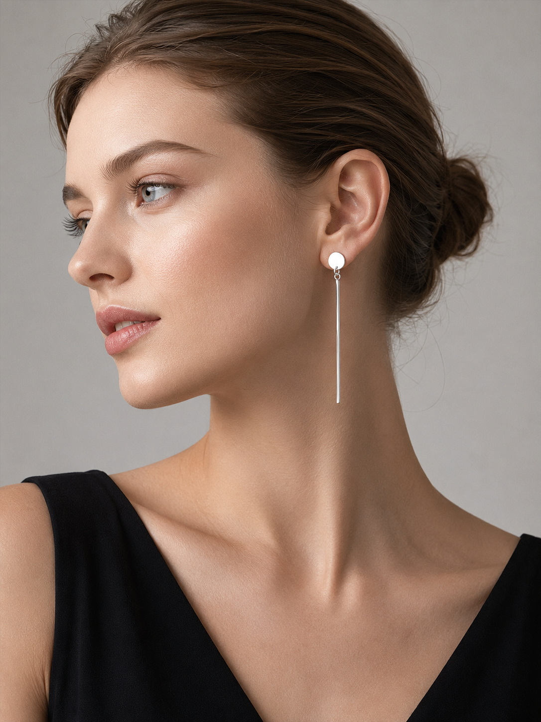 European model wearing handmade 925 sterling silver drop square bar earrings with a black top on a light gray studio background.