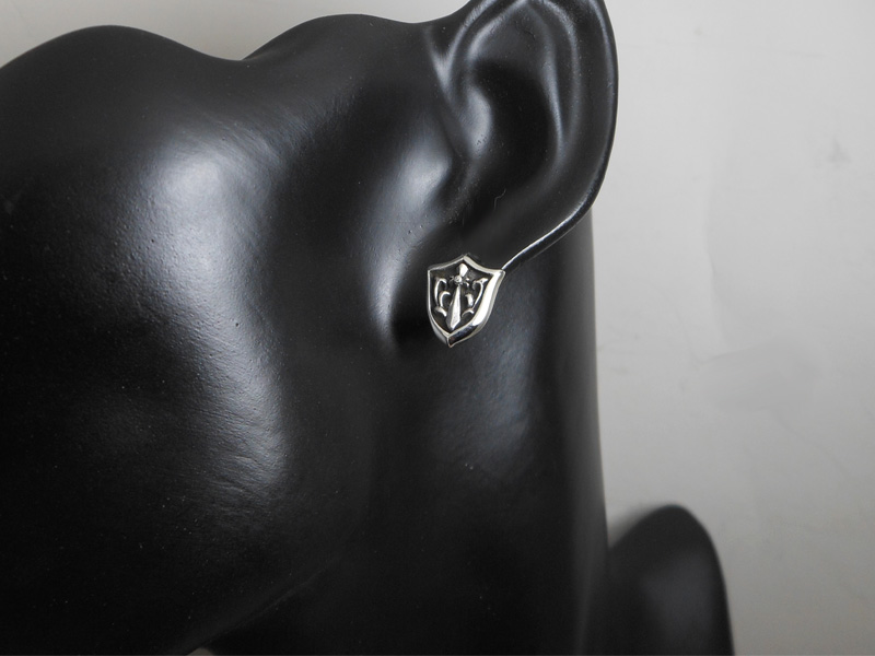 Sterling silver sword and shield stud earrings displayed on a mannequin ear bust.