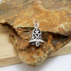 Sup Silver handcrafted 925 sterling silver fleur-de-lis bell pendant main view featuring intricate oxidized filigree on a natural stone background.
