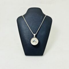 Front view of a minimalist 20mm silver hollow sphere pendant on a black jewelry display stand.