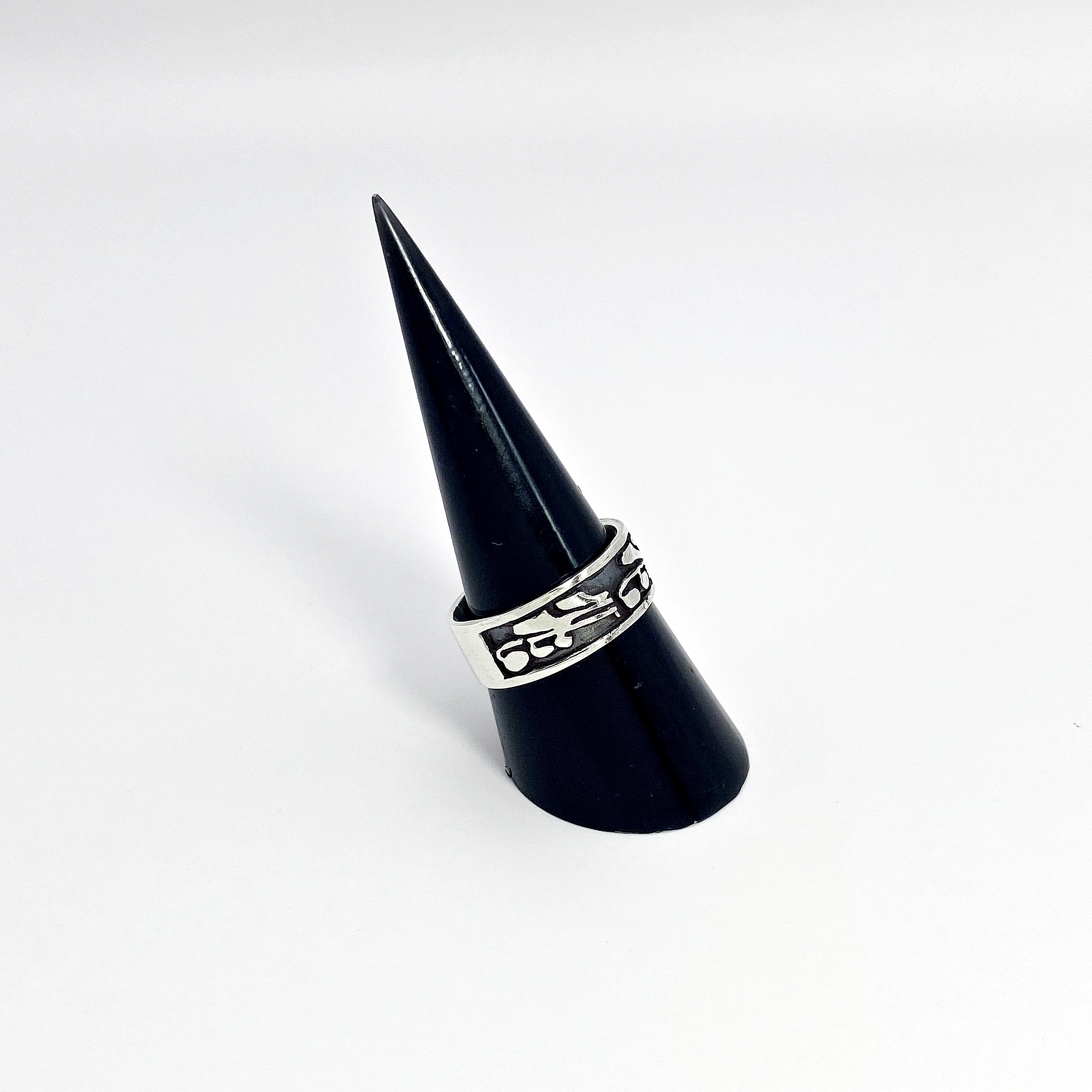 Left side view of the oxidized silver leaf ring on a minimalist black display stand.