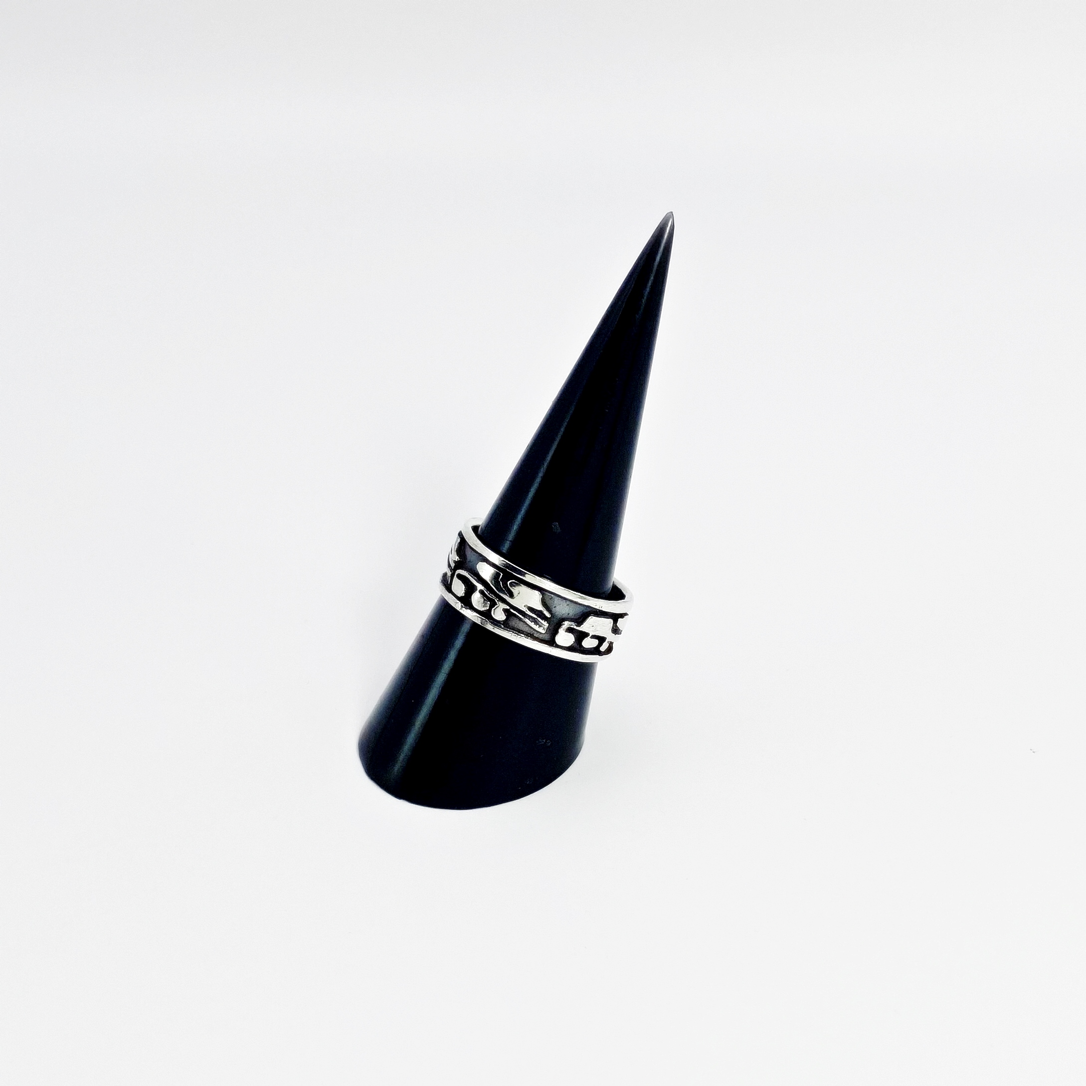Right side view of the detailed silver leaf pattern ring on a black jewelry stand.