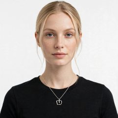 Model wearing a delicate 925 sterling silver cutout apple pendant necklace.