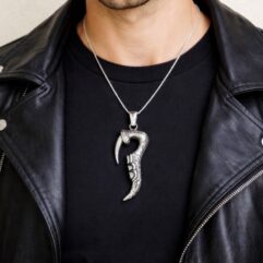 Detailed close-up of the 925 silver claw pendant worn by a male model.