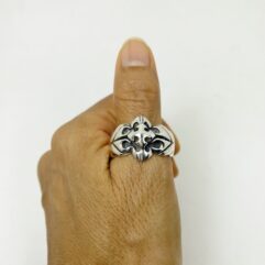 Front view of a sterling silver oxidized shield ring showing the intricate cross detail.