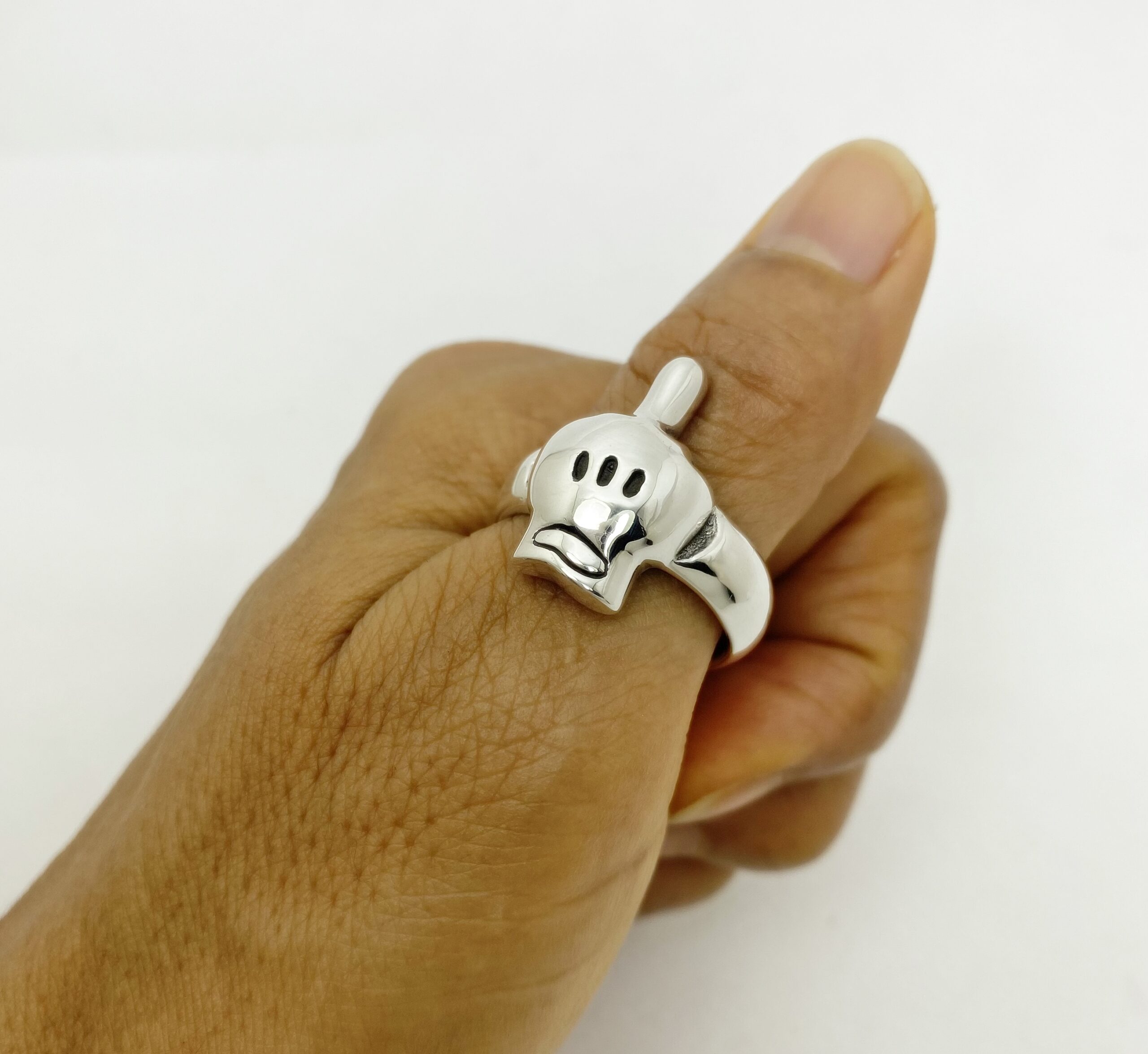r308c-cartoon-hand-skull-ring-handcrafted-925-silver Unique middle finger cartoon hand skull ring handcrafted from 925 sterling silver, showcased on a model's finger by Sup Silver.
