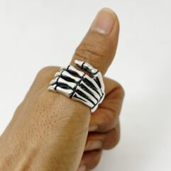 Side view of a detailed 925 sterling silver skeleton hand ring by Sup Silver showing the bone structure.