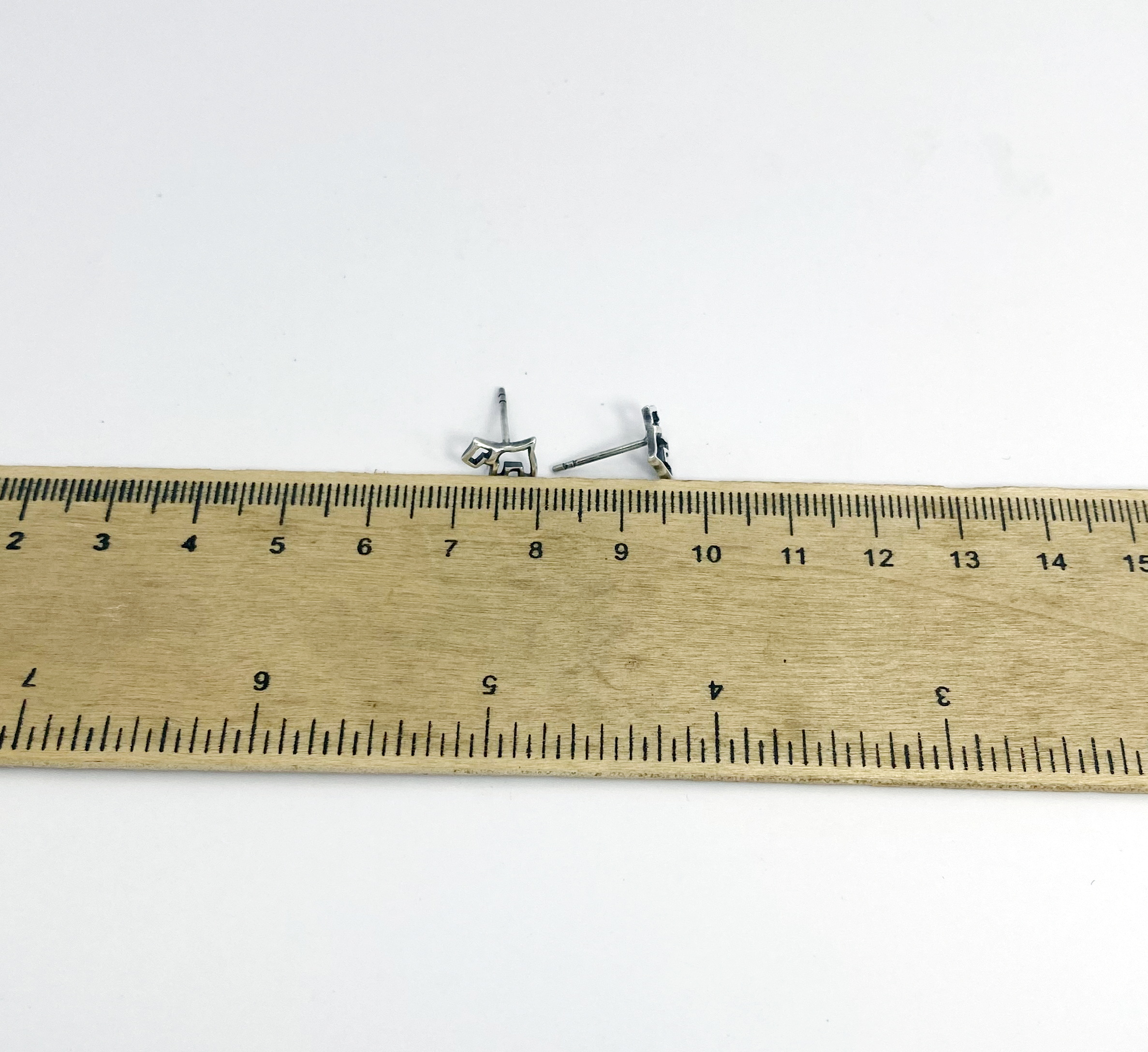 size measurement of 925 sterling silver scottish terrier dog stud earrings next to ruler