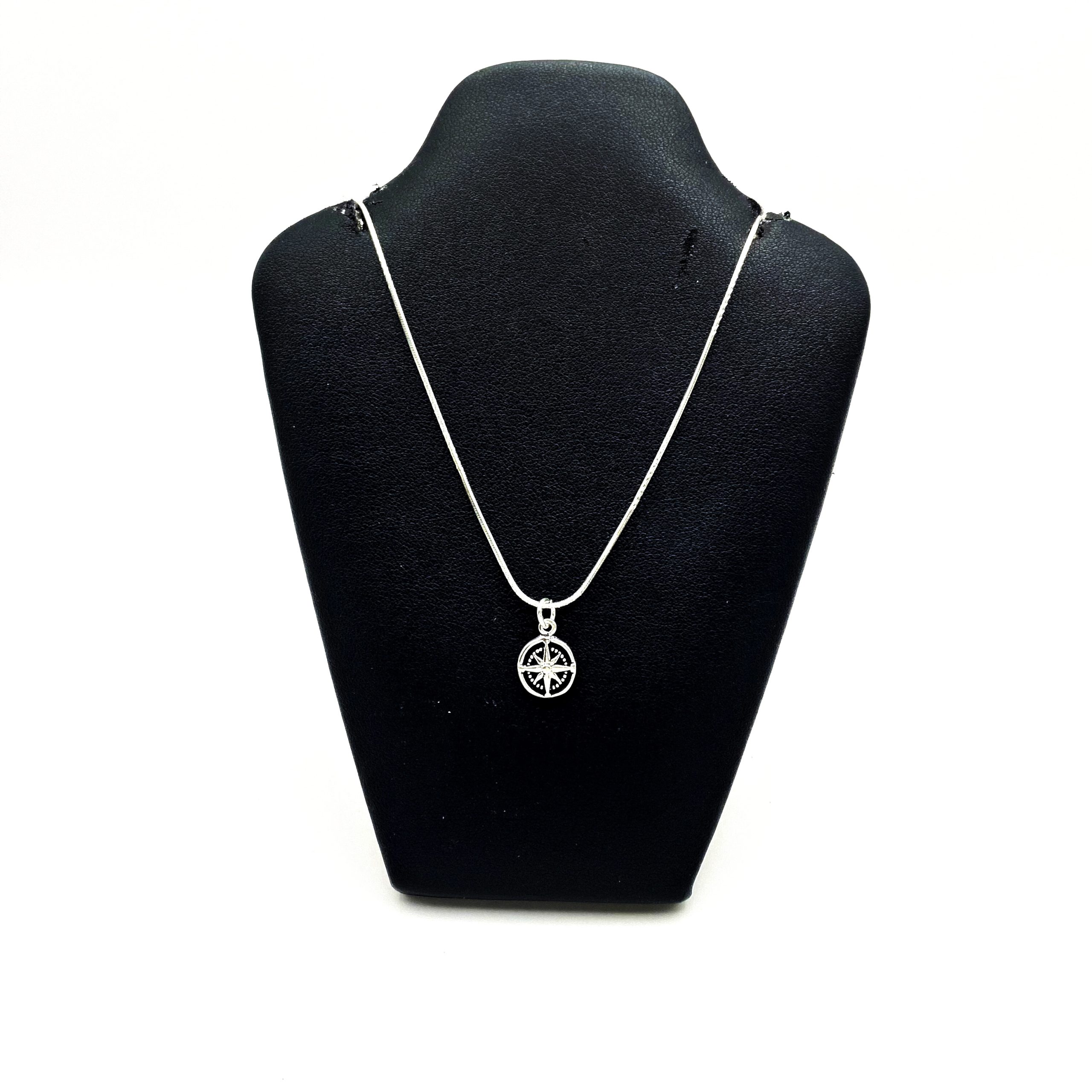 Sup Silver 925 sterling silver compass rose pendant displayed on a black jewelry neck bust.